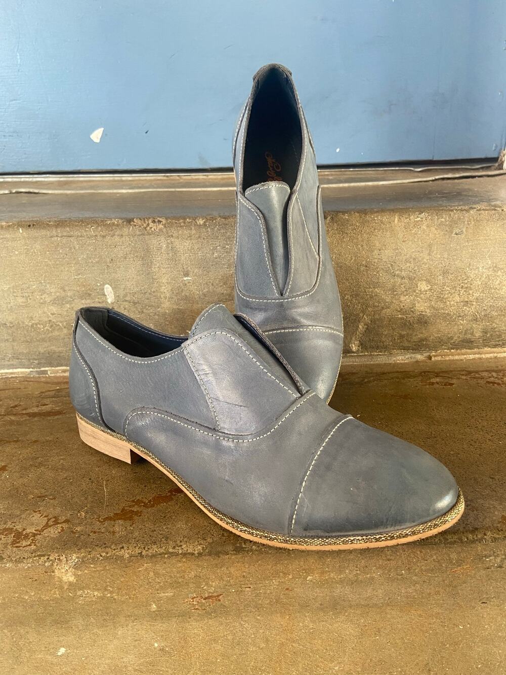 Naughty Monkey Slip Knot blue leather loafers with contrast stitching.